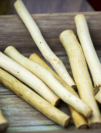 Carved ivory-colored cultural materials rest on a wooden surface.