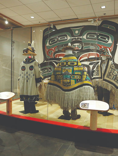 Regalia and clan artwork displayed in a Sealaska Heritage exhibit