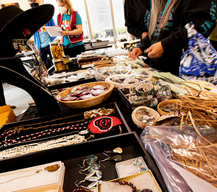 Handcrafted jewelry and woven artwork displayed at the Native Artist Market