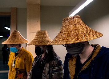 Students wearing woven spruce-root hats during an arts class