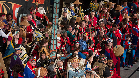 A large group of Celebration dancers in colorful regalia