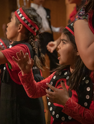 Elementary students performing in traditional regalia