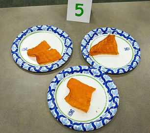 Three numbered traditional food entries arranged on paper plates