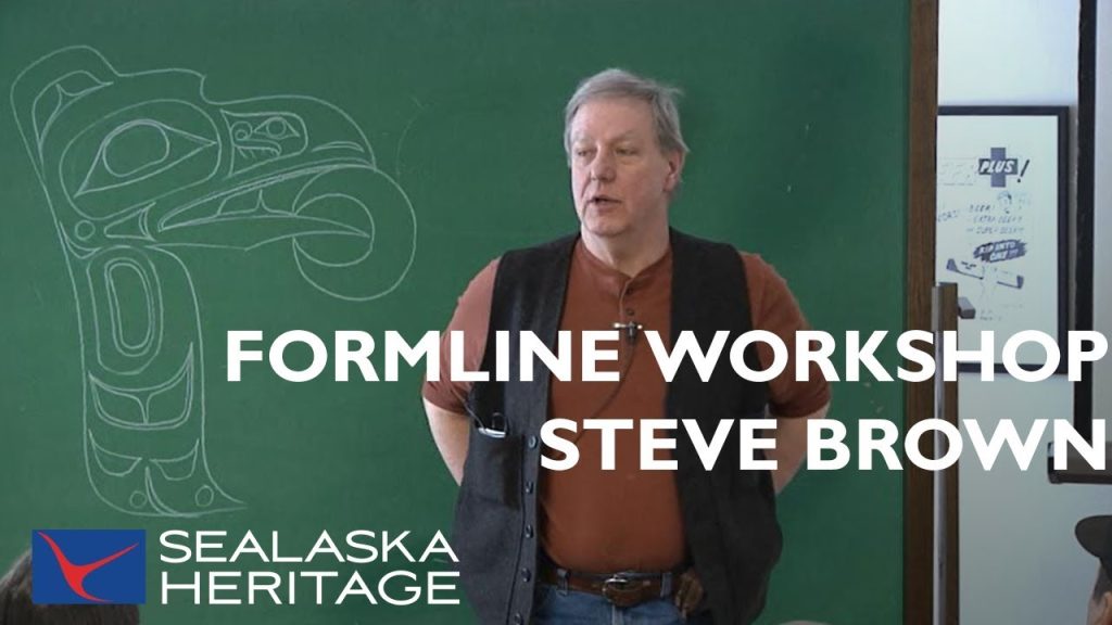 Steve Brown teaching Northwest Coast formline design at a classroom chalkboard