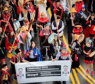 Celebration 2022 participants carry the Wrangell community banner in the parade