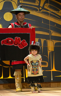 A family models red and black regalia at Celebration