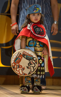 A young child models colorful regalia at Celebration