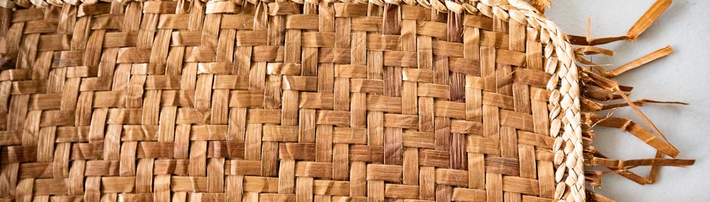 Close view of a woven spruce-root basket and its braided edge