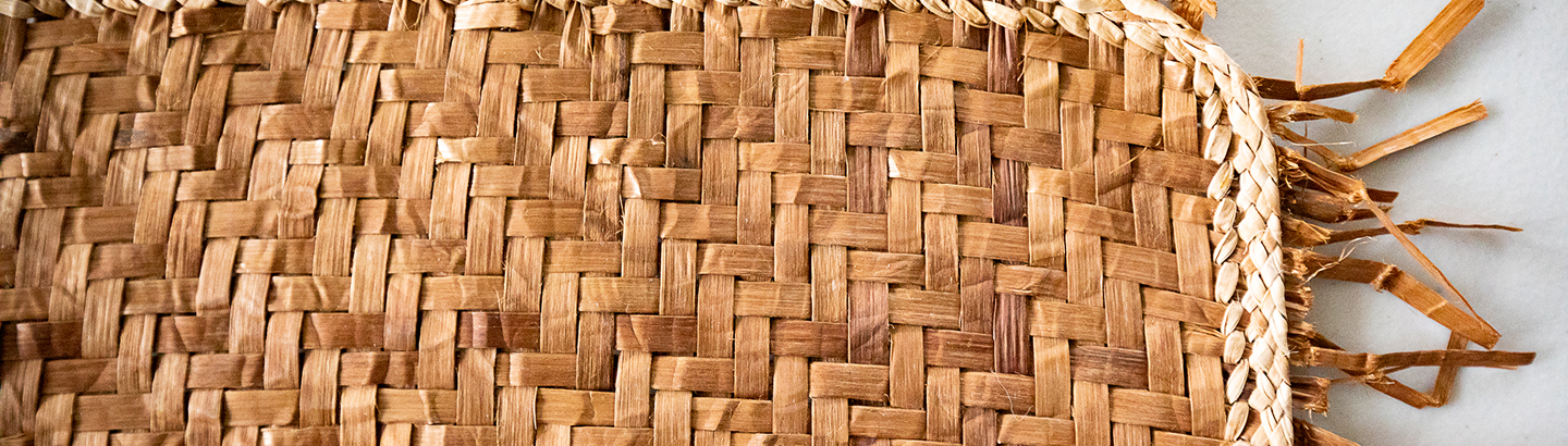 Close view of a woven spruce-root basket and its braided edge