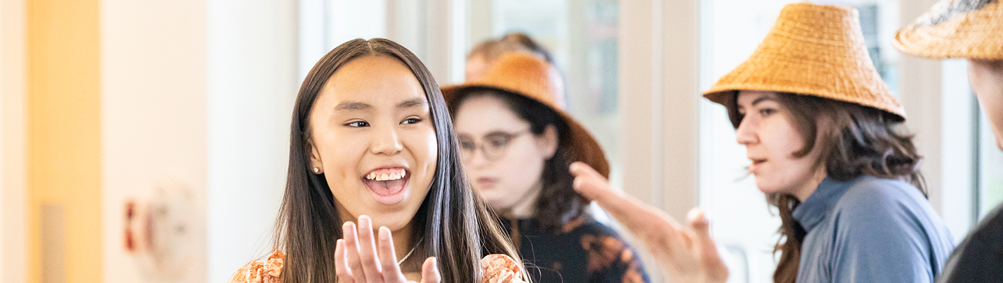 Young performers singing and gesturing during a workshop