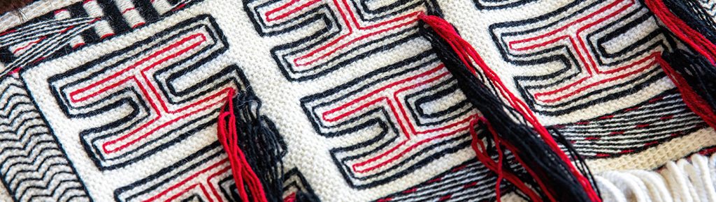 Black and red woven Northwest Coast designs with tassels