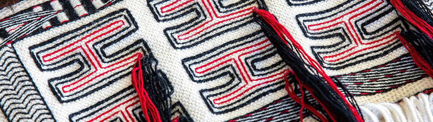 Black and red woven Northwest Coast designs with tassels