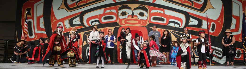 Children and families model regalia on the Celebration stage