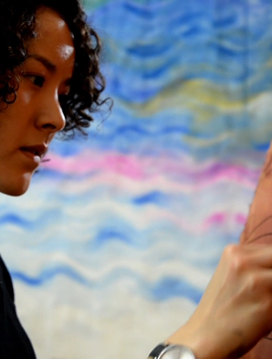 An artist painting a Northwest Coast design