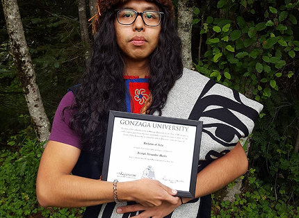 A Language Studies scholarship recipient holding a Gonzaga University diploma