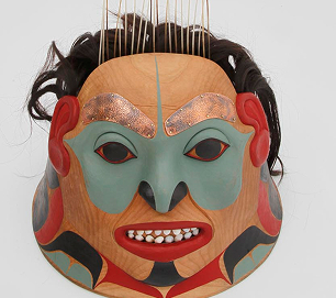 A carved and painted Northwest Coast mask with human hair
