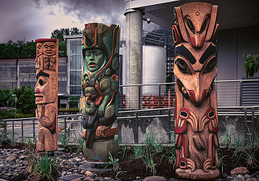 Three carved Northwest Coast house posts outside the Walter Soboleff Building