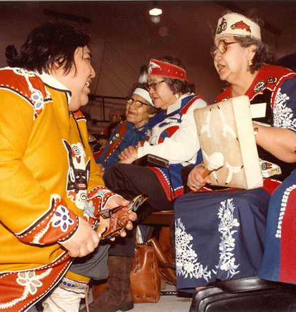 Women in regalia visiting together during Celebration