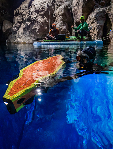 A diver and researchers documenting a carved panel underwater