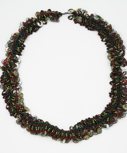 A necklace intricately woven from black seaweed and colorful beads