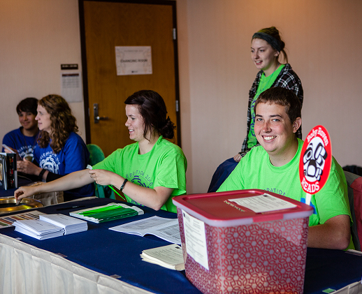Celebration volunteers welcoming attendees at a registration table