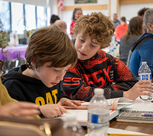 Two students working together on a classroom writing assignment