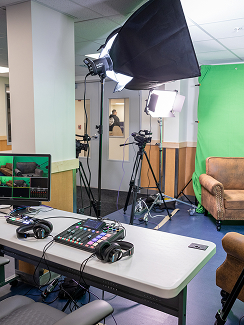 Cameras, lighting, audio equipment, and green screen in the Digital Media Lab