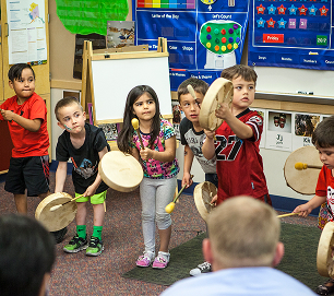 Children participating in a Baby Raven Reads drumming activity
