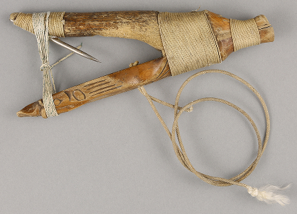 Carved traditional halibut hook wrapped with cordage