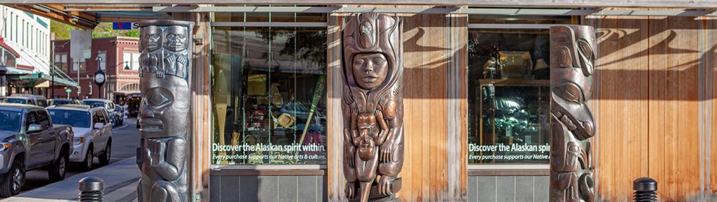 Three bronze house posts outside the Walter Soboleff Building in downtown Juneau