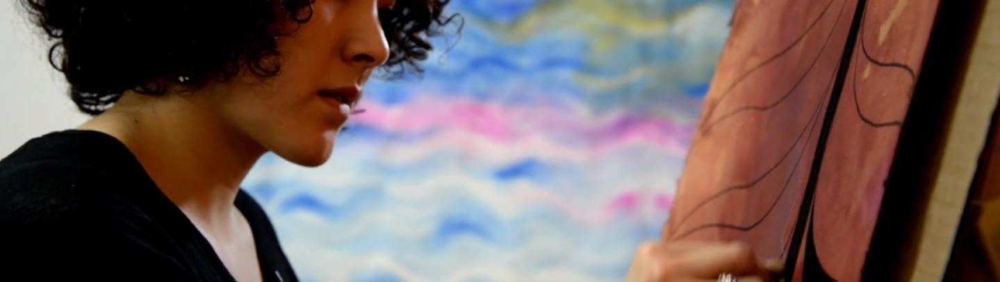 An artist painting a Northwest Coast design