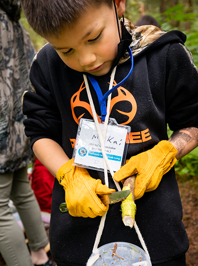 An elementary student taking part in an outdoor Raven Writes camp activity