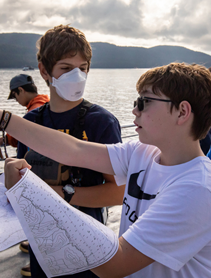 Students study a chart during an Indigenous Science Academy boat trip
