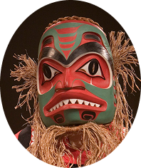 Red and green mask surrounded by cedar bark