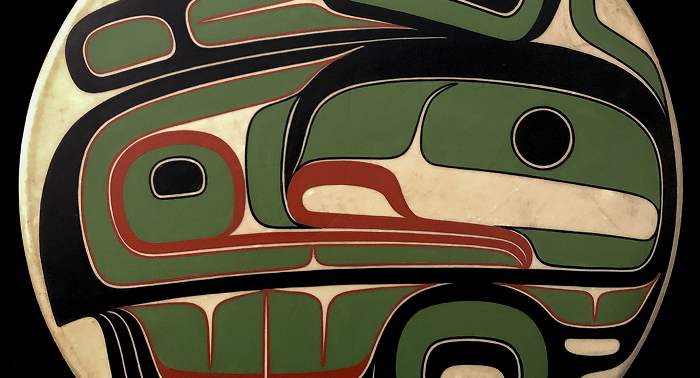 Detail of a circular Northwest Coast art design in black, red, green, and cream