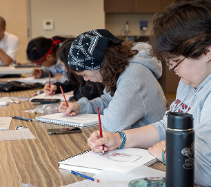 Atnané Academy students drawing formline designs together