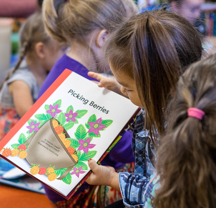 A child reading Picking Berries during a group activity