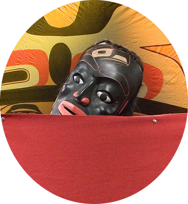 Spirit mask peeking above a red panel