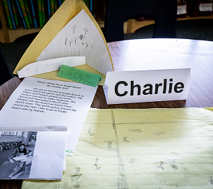 A student writing project displayed on a classroom table
